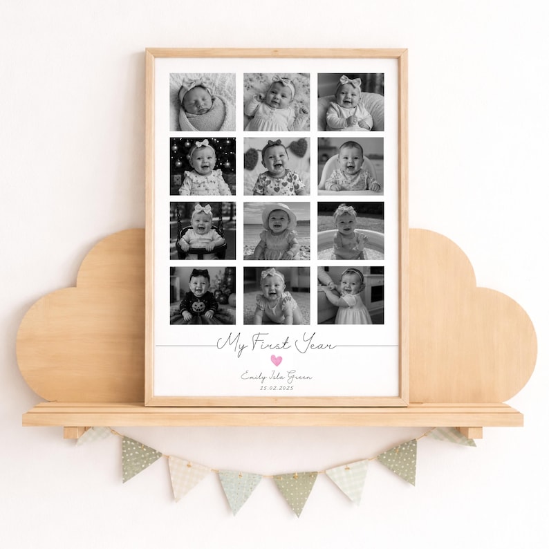 May include: A rectangular wooden frame containing a collage of twelve black and white baby photographs. Below the photos, the text reads My First Year, followed by the name Emily Isla Green and the date 25.02.2025 with a small pink heart.