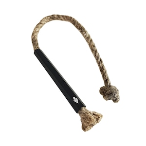May include: A black fire starter with a rope handle. The rope is made of natural fibres and has a knot at the end. The fire starter has a diamond logo on the side.