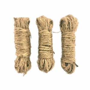 May include: Three spools of natural brown twine, each wrapped in a tight coil.