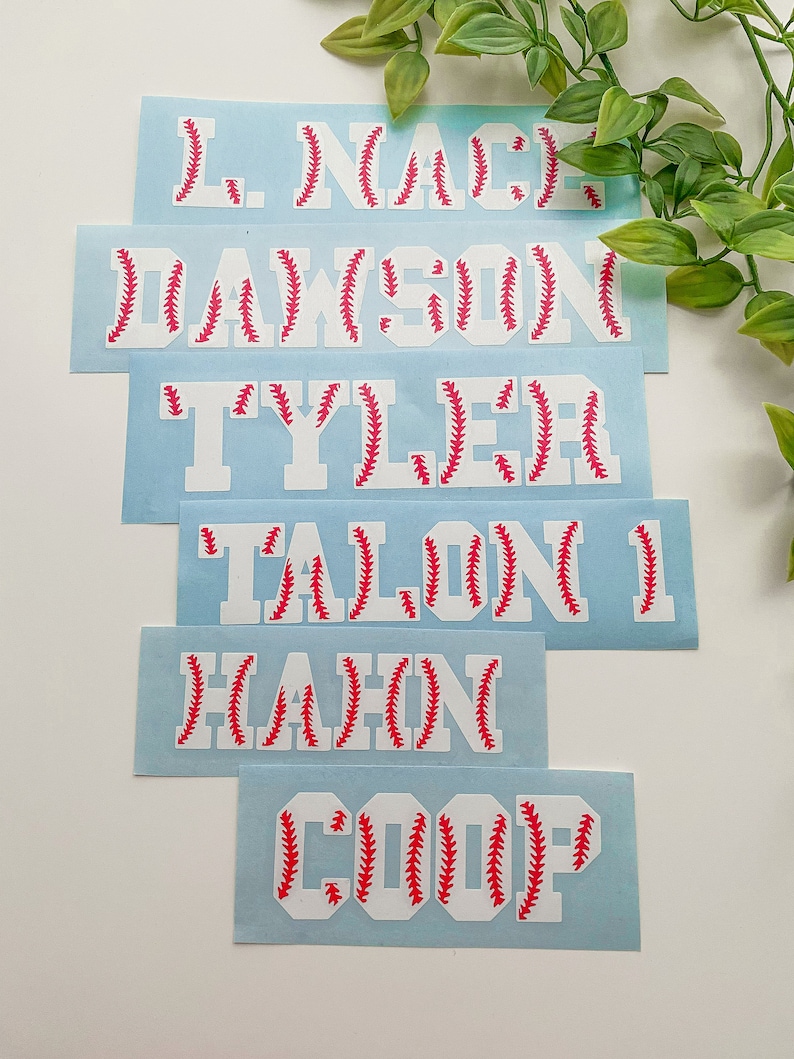 May include: Six white vinyl decals with red baseball stitching. The decals feature the names: L. Nace, Dawson, Tyler, Talon, Hahn, and Coop.