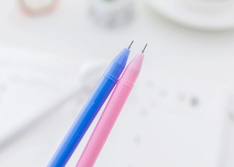 May include: Two pens, one blue and one pink, with silver tips.