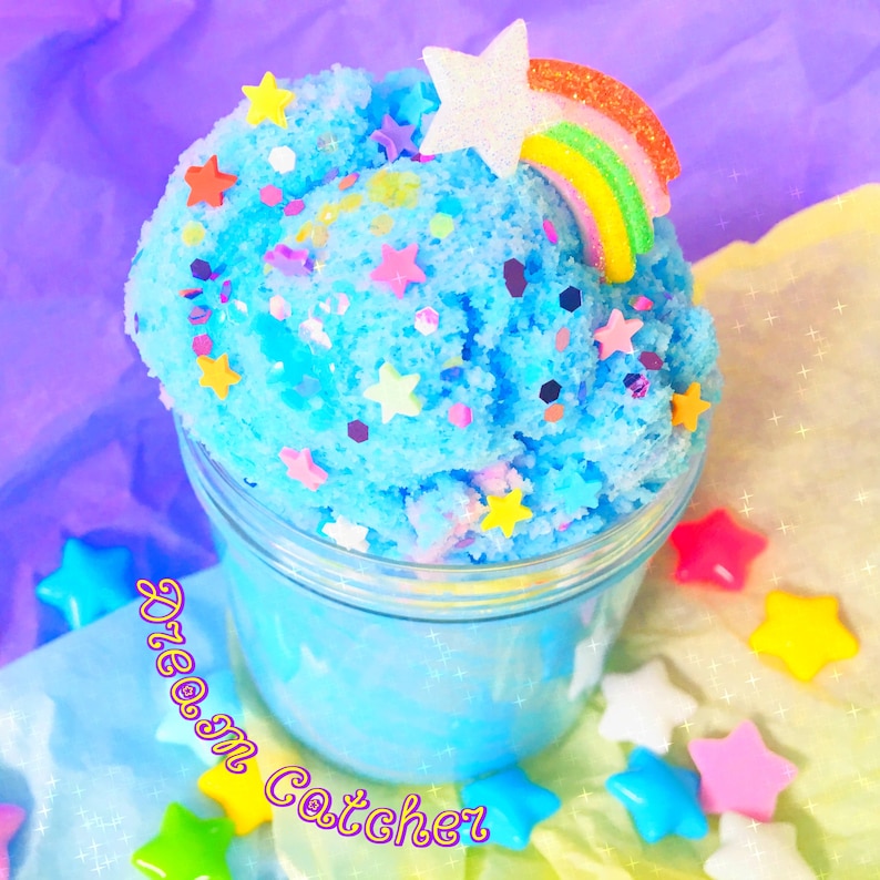 May include: A blue slime with a rainbow and star topper in a clear glass jar. The slime is covered in colourful sprinkles and stars. The jar is labelled "Dream Catcher".