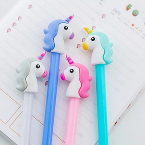 May include: Four unicorn-shaped pens with different colored bodies: blue, pink, light blue, and white. The unicorn heads are all white with different colored manes and horns.