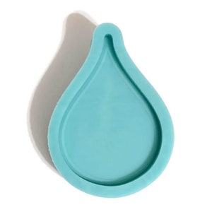 Könnte beinhalten: Eine hellblaue Silikonform in Tropfenform. Die Form ist für das Gießen von Harz ausgelegt.