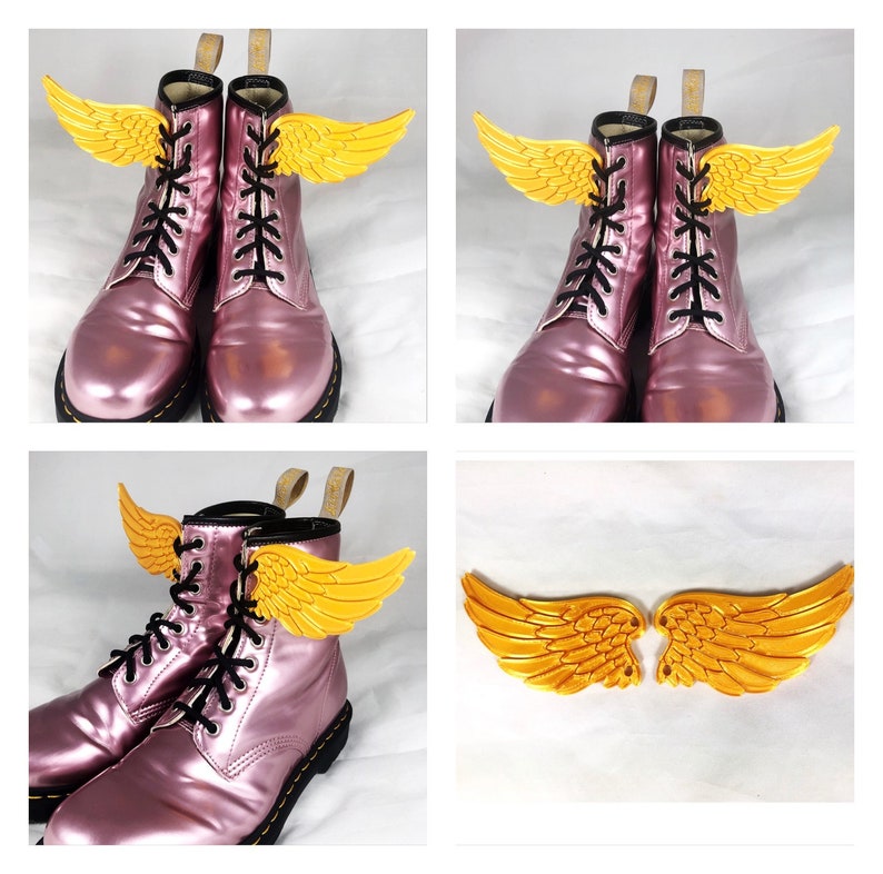 May include: A pair of pink leather boots with gold wings attached to the laces. The wings are a decorative element and are not functional.