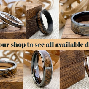 May include: A collage of six different wood and metal rings. The rings are all unique and feature different wood patterns and metal finishes. Visit our shop to see all available designs.