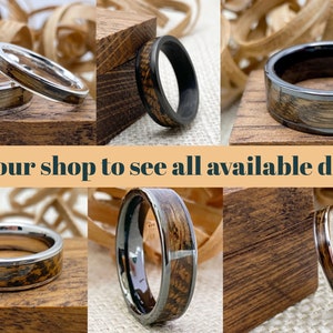 May include: A collage of six different wood and metal rings. The rings are all unique and feature different wood patterns and metal finishes. Visit our shop to see all available designs.
