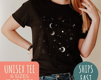 May include: A black unisex t-shirt with a white graphic of moons and stars. The text "Unisex Tee", "6 Sizes", and "12 Colors" is on the left side of the image. The text "Ships Fast" is on the right side of the image.