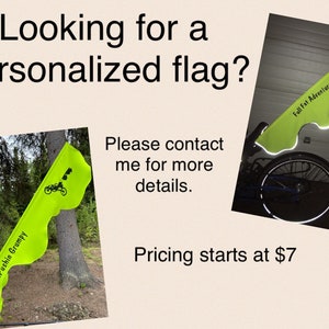 May include: Two custom-made flags with reflective material. The first flag is green with black text that reads "Pedal Pushin Grumpy". The second flag is green with black text that reads "Full Fat Adventurer".