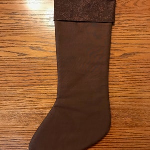 May include: A brown Christmas stocking with a brown and white patterned cuff.