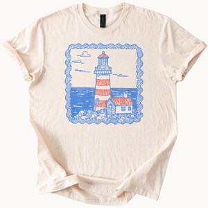 Lighthouse Graphic T Shirt Coastal Ocean Nautical Scene Beach House Illustration Sea Art Unisex Soft Cotton Tee Summer Gift
