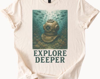 May include: A beige t-shirt with a vintage-style illustration of a diving helmet in an underwater scene. The text "EXPLORE DEEPER" is printed in green below the illustration.