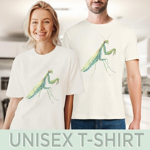 May include: White unisex t-shirt with a green praying mantis graphic printed on the front.