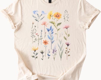 Op de afbeelding: Een beige T-shirt met een bloemenprint met verschillende gekleurde bloemen, waaronder blauwe, gele, oranje, roze en paarse.