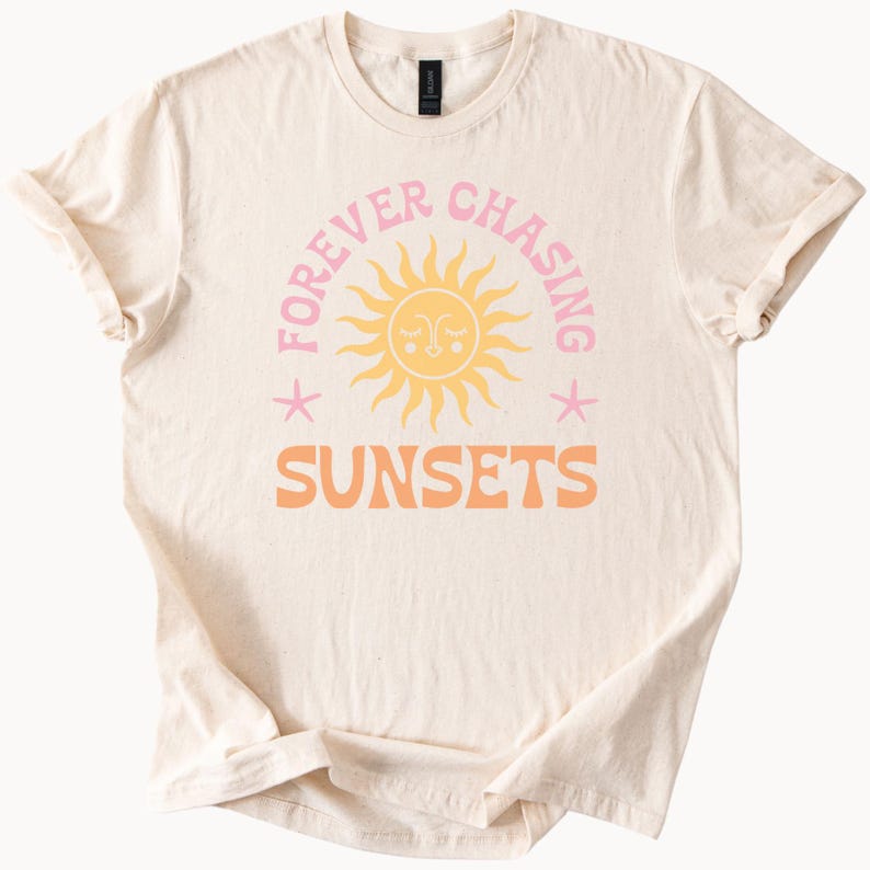 May include: A beige t-shirt with a pink and orange graphic design that says "Forever Chasing Sunsets" with a cartoon sun in the middle.