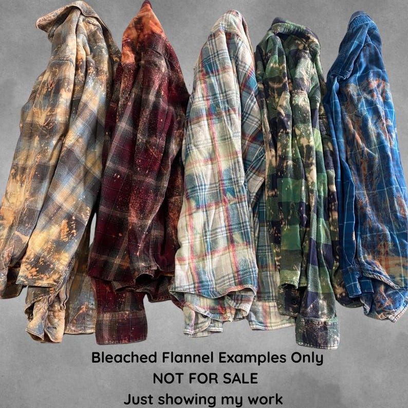 May include: Five bleached flannel shirts in different colors and patterns. The shirts are folded and stacked on top of each other. The text "Bleached Flannel Examples Only NOT FOR SALE Just showing my work" is at the bottom of the image.