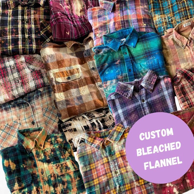 May include: A collection of custom bleached flannel shirts in various colors and patterns, including red, blue, green, brown, and black. The shirts are stacked on top of each other and have a distressed, vintage look. The text "CUSTOM BLEACHED FLANNEL" is written in white on a purple circle.