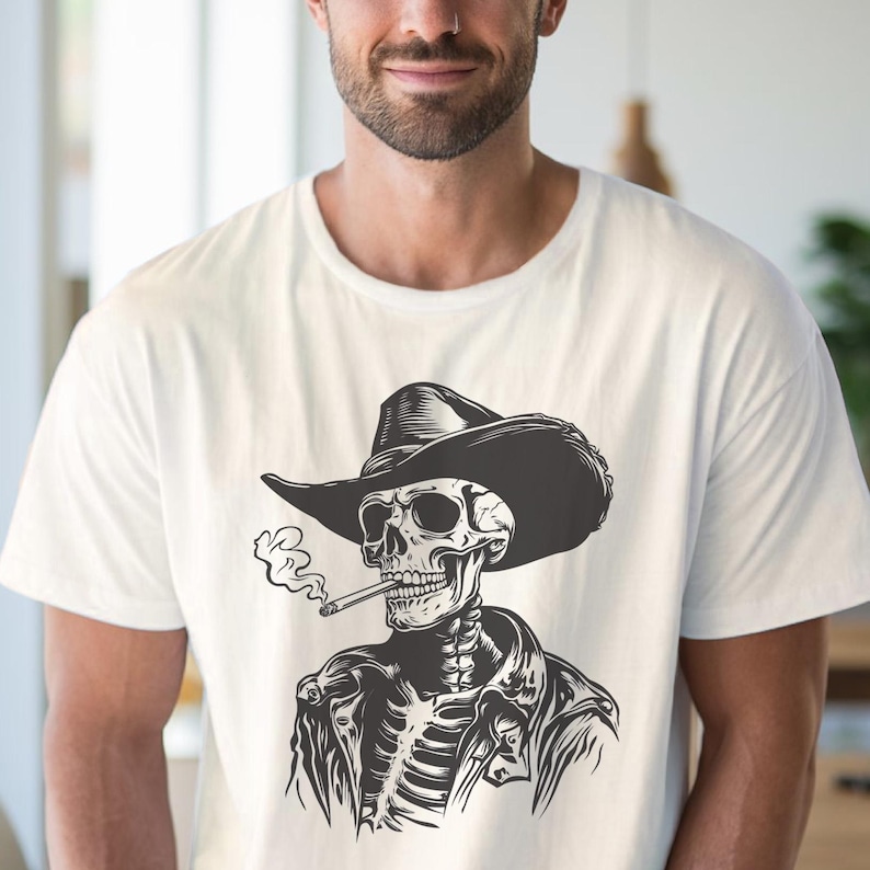 May include: White t-shirt with a black and white illustration of a skeleton in a cowboy hat and leather jacket, smoking a cigarette. The design is detailed, showing the rib cage and skull in a stylized manner.