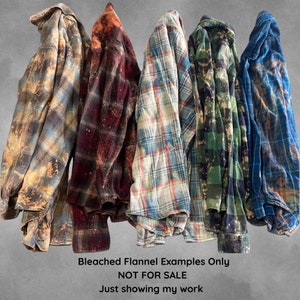May include: Five bleached flannel shirts in different colors and patterns. The shirts are folded and stacked on top of each other. The text "Bleached Flannel Examples Only NOT FOR SALE Just showing my work" is printed below the shirts.