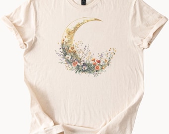 Maglietta con luna crescente e motivi floreali, maglietta con grafica botanica, maglietta boho celeste