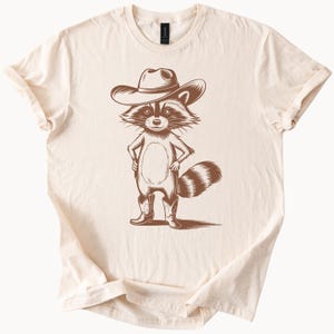 Cowboy wasbeer grafisch T-shirt met westernlaarzen en hoed land dier illustratie rustiek wild cartoon ontwerp T-shirt