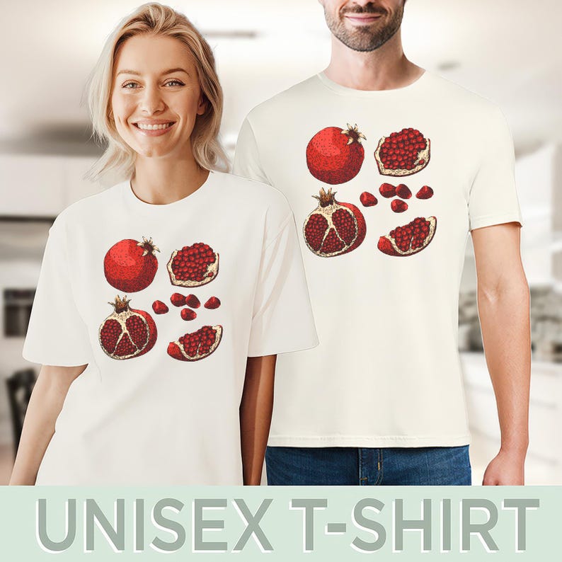 May include: Off-white unisex t-shirts featuring a detailed illustration of pomegranates. The design includes whole and sliced pomegranates in shades of red and brown. The text "UNISEX T-SHIRT" is at the bottom.