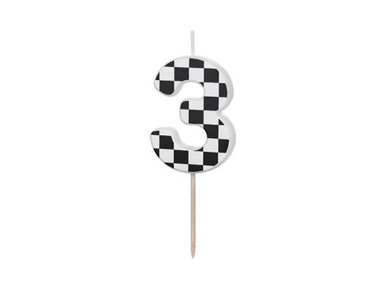 May include: Black and white checkered number three birthday candle. The candle is on a wooden stick.