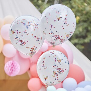 May include: Three white balloons with confetti inside. The balloons are decorated with colorful confetti and are tied together with a string.