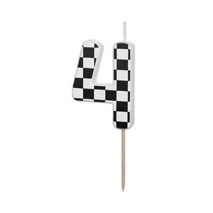 May include: A white birthday candle shaped like the number four with a black and white checkered pattern.