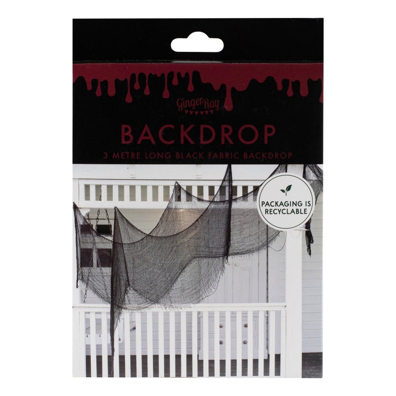 May include: Black fabric backdrop for Halloween decorations. The packaging reads "BACKDROP" and "3 METRE LONG BLACK FABRIC BACKDROP". The backdrop is draped over a white porch railing. The packaging is labeled "PACKAGING IS RECYCLABLE".