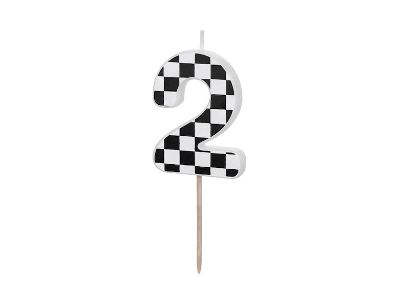 May include: Black and white checkered number two birthday candle. The candle is on a wooden stick.