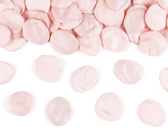 May include: A scattering of light pink rose petals on a white background. The petals are arranged in a semi-circle shape, with some petals overlapping.