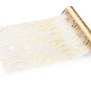 May include: A roll of gold and white decorative wrapping paper with a textured, metallic finish.