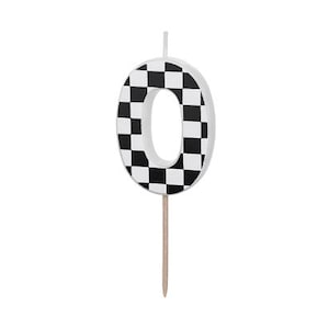 May include: Black and white checkered number zero birthday candle. The candle is on a stick.