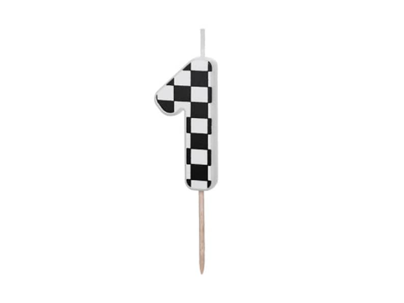 May include: Black and white checkered number one candle with a wooden stick.