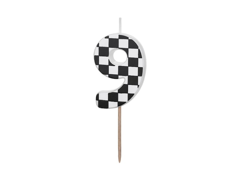 May include: Black and white checkered number nine birthday candle.