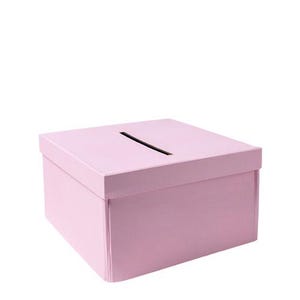 May include: A light pink, square box with a slot cut into the top. The box has a lid and is likely made of cardboard or a similar material. The box is a solid color and has a simple, clean design.