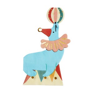 May include: A light blue seal balancing a striped ball on its nose. The seal wears a red hat and a pink ruffled collar. It stands on a colourful, triangular base, evoking a circus theme.