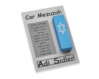 May include: A white card with the text "Car Mezuzah" and "Adi Sidler" printed on it. A blue mezuzah with a white Star of David is attached to the card.