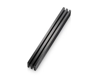 May include: A black metal drawer pull with a rectangular shape and three vertical grooves.