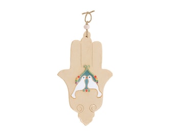 May include: A beige ceramic Hamsa hand wall hanging with a blue and green birdhouse design and two white doves inside. The Hamsa hand is decorated with colorful details and has a string for hanging.