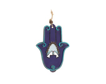 May include: A purple Hamsa hand wall hanging with a blue outline and two white doves inside. The Hamsa hand is a symbol of protection and good luck.