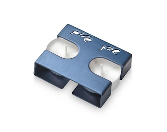 May include: A blue metal candle holder with two white tea lights. The holder has the word "Peace" cut out in the metal.