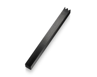 May include: A black metal ruler with a jagged edge at one end.