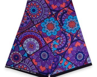 Könnte beinhalten: Gefalteter Stoff mit einem lebendigen, geometrischen Blumenmuster in Lila-, Blau- und Koralltönen. Der Stoff weist ein sich wiederholendes Design aus stilisierten Blumen und kreisförmigen Motiven auf. Der Text "ANTEED WAX COTTON AFRICANFABS HOLLAND" ist am Rand aufgedruckt.