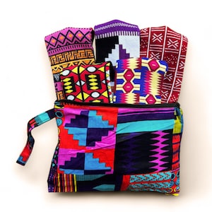 May include: A colorful zippered pouch with a geometric pattern. The pouch is filled with five patterned fabric squares.