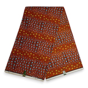 Może przedstawiać: Pomarańczowa i żółta tkanina z geometrycznym wzorem w kolorze białym i czarnym. Tkanina ma białą obwódkę, a na dole nadrukowany jest tekst "14/0001".