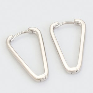 May include: A pair of silver triangle hoop earrings. The earrings are open and have a simple, minimalist design.