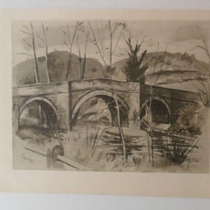 May include: A sepia watercolour painting depicting a stone bridge with three arches over water. Bare trees and a distant hillside are in the background. The artwork is signed in the lower left corner.