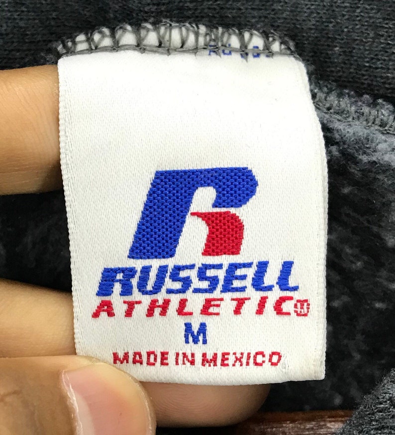 May include: White tag with a red and blue "R" for Russell Athletic. The tag also says "Made in Mexico" and "M" for size.